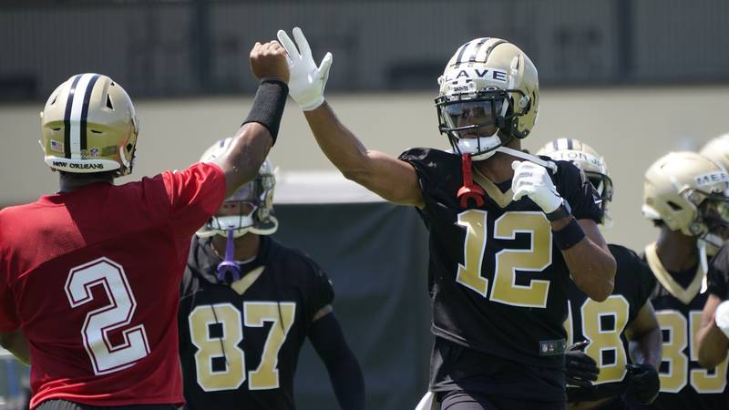 New Orleans Saints first round draft pick, wide receiver Chris Olave (12), high fives...
