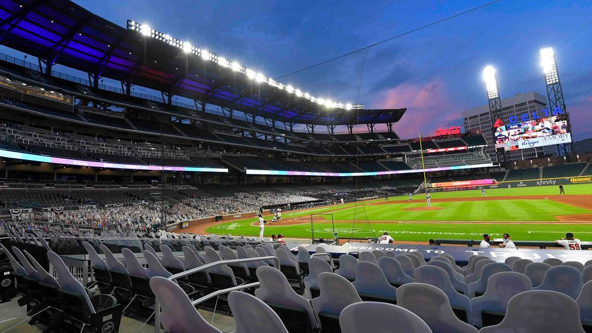FILE - This photo from Thursday July 30, 2020, shows cardboard cutouts of fans in seats during...