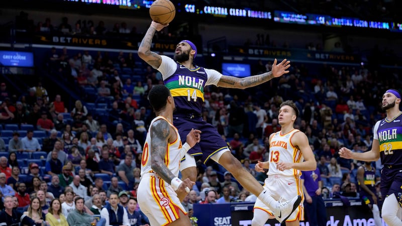 Pelicans forward Brandon Ingram (14) shoots over Atlanta forward John Collins (20) in the...