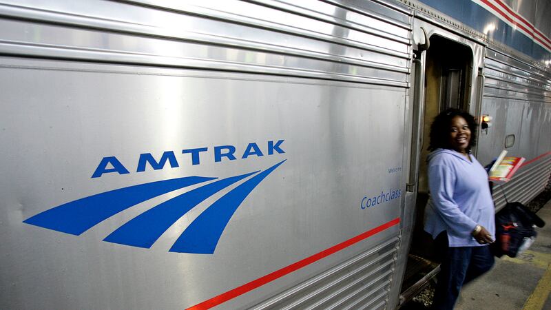 FILE - A passenger disembarks from Amtrak's Sunset Limited at its final stop in New Orleans,...