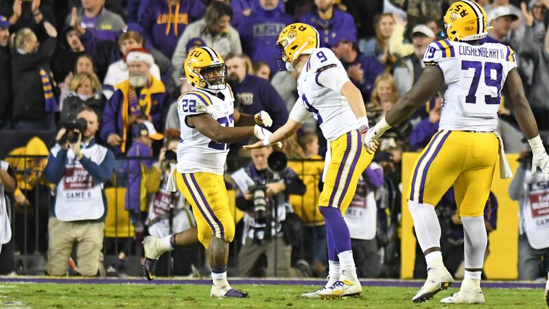 LSU quarterback Joe Burrow celebrates with running back Clyde Edwards-Helaire after a...