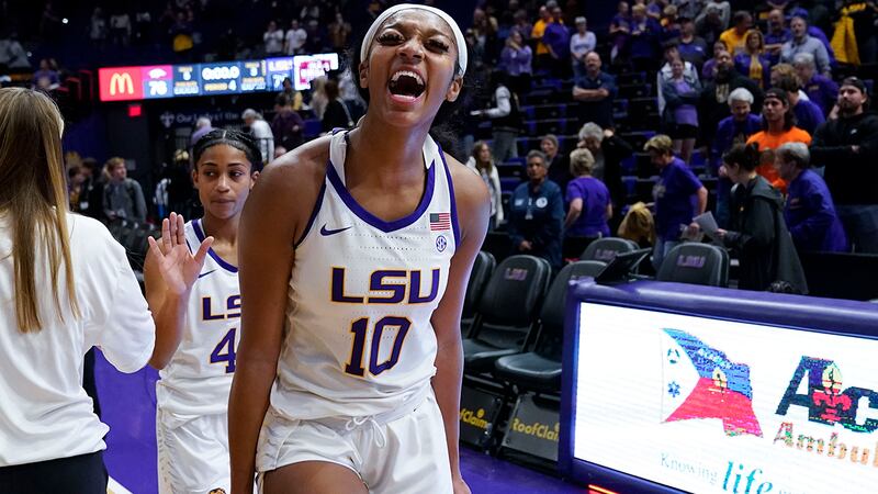 LSU forward Angel Reese (10) reacts after defeating Arkansas in an NCAA college basketball...
