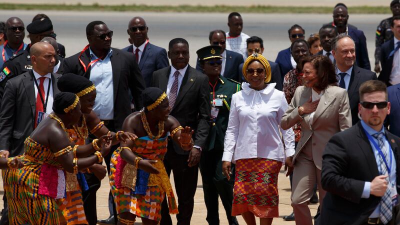 U.S. Vice President Kamala Harris is greeted by traditional dancers as she arrives in Accra,...