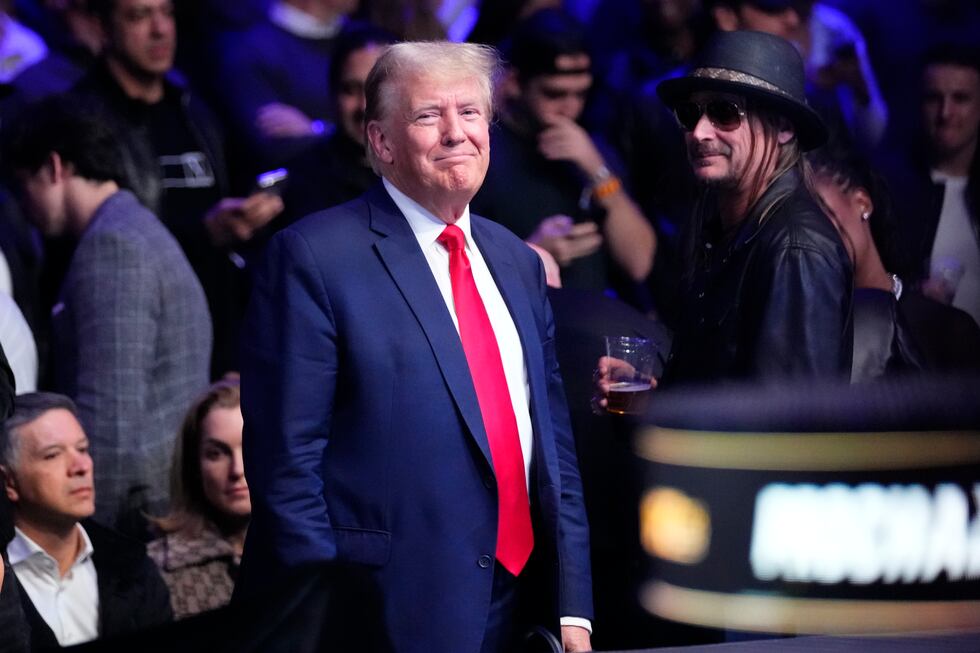 Former President Donald Trump smiles while attending the UFC 295 mixed martial arts event...