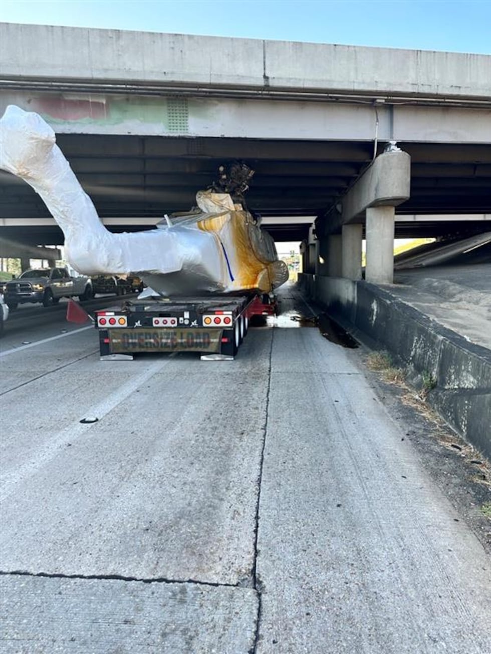 Officials respond after helicopter stuck under I-12 on S. Range Avenue in Denham Springs.