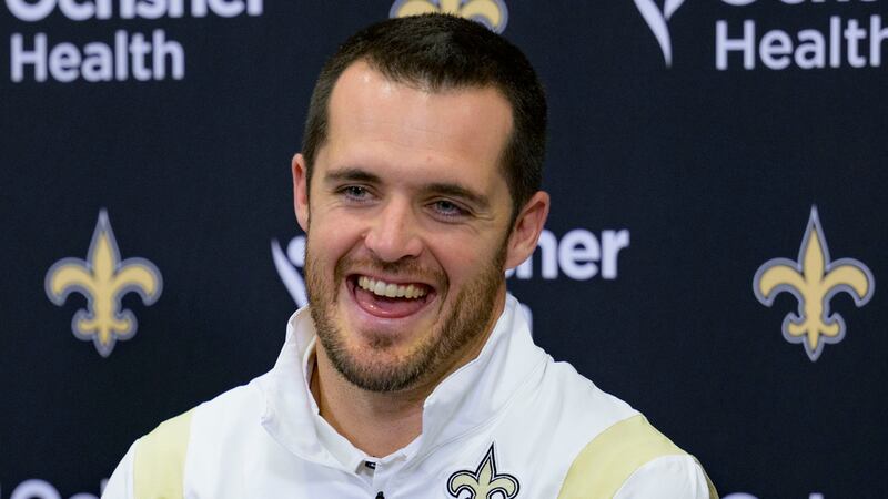 Derek Carr smiles as he is introduced as the new quarterback of the New Orleans Saints during...