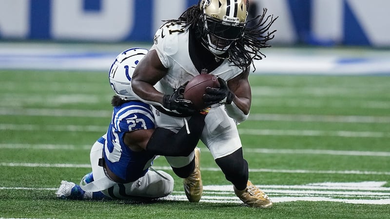 Saints running back Alvin Kamara (41) is tackled by Indianapolis cornerback Dallis Flowers...