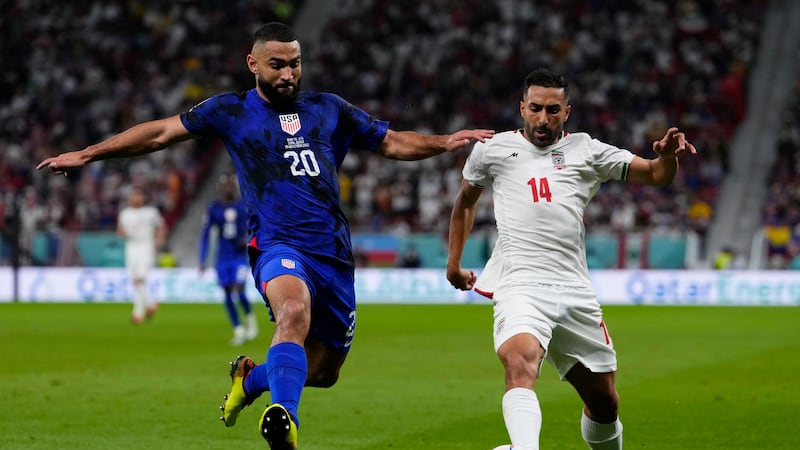 Cameron Carter-Vickers of the United States, left, challenges Iran's Saman Ghoddos during the...