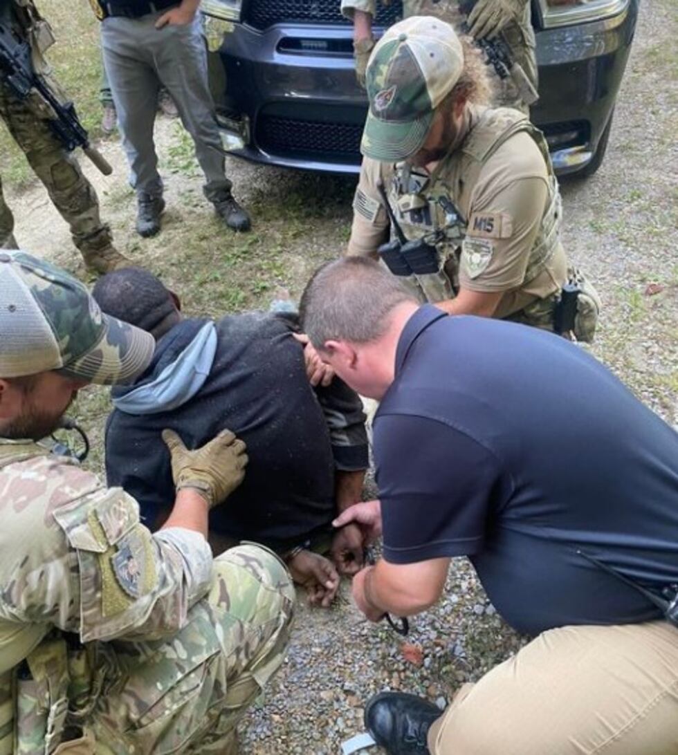 Erin (Tenn.) Police Chief Mark Moore handcuffs New Orleans murder suspect B.J. Brown on...