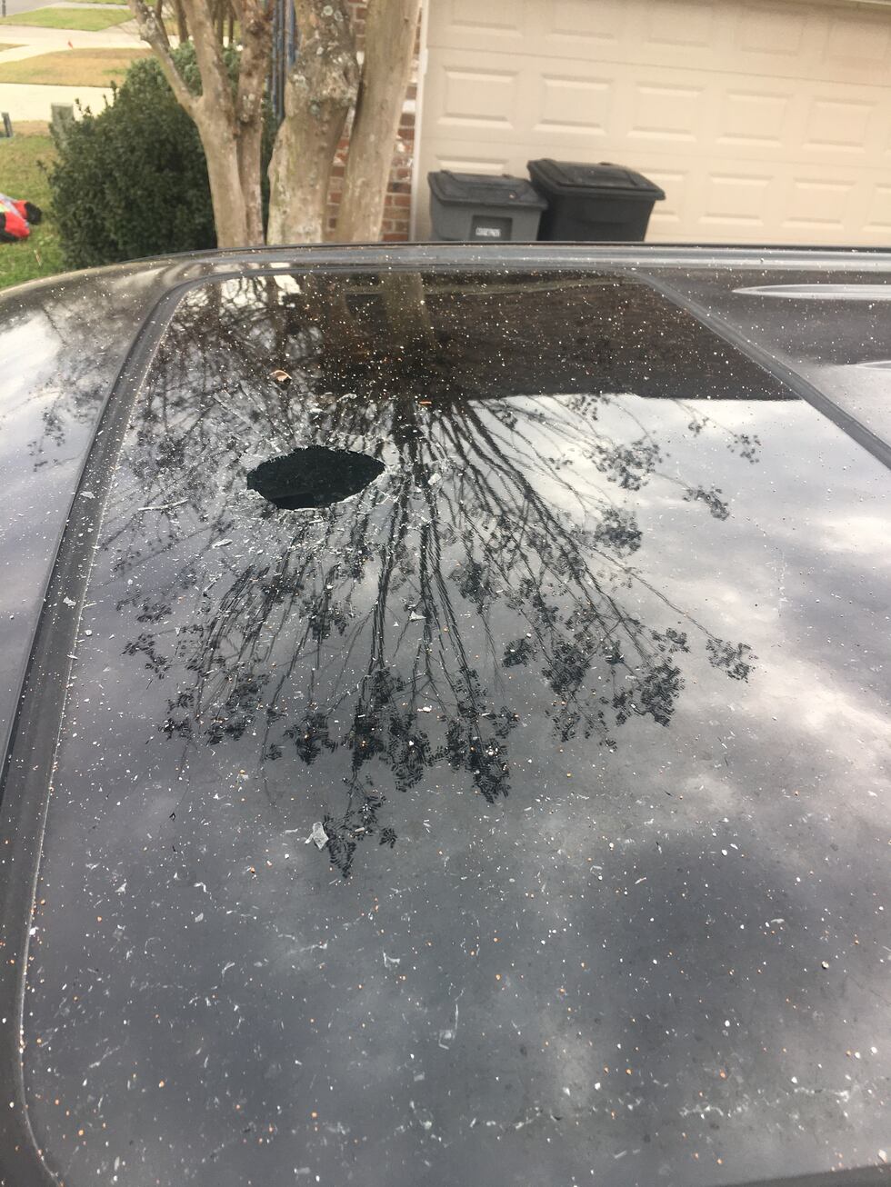 A bullet fell through the sunroof of a man's car on New Year's Eve.