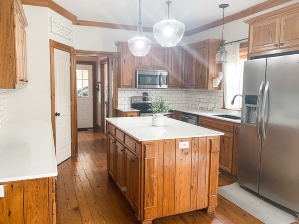 The owner of this kitchen also updated the countertops, changed the backsplash, and switched...