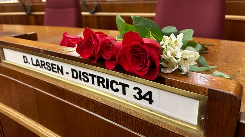 Roses rest on the Senate desk of late North Dakota Republican state Sen. Doug Larsen, at the...
