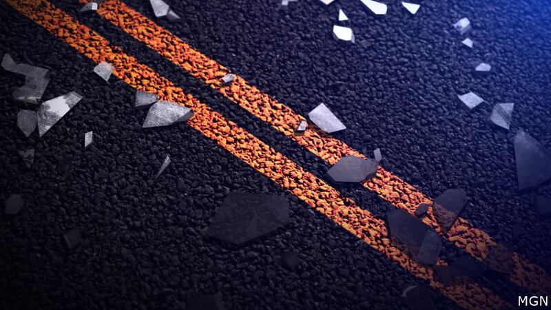 Car accident notification showcasing broken glass on the center line of the street.