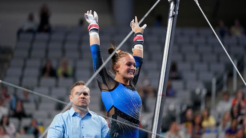 Florida's Savannah Schoenherr celebrates after competing on the uneven bars during the NCAA...