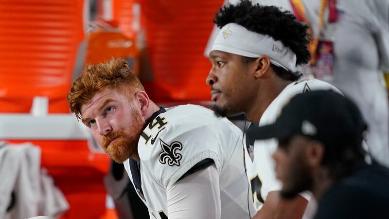 New Orleans Saints quarterback Andy Dalton, left, and quarterback Jameis Winston watch during...