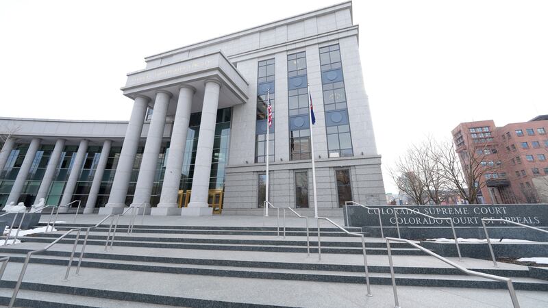 FILE - Flags stand outside the Colorado Supreme Court, on Jan. 17, 2023, in Denver. Colorado’s...