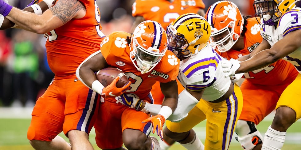 Clemson running back Travis Etienne carries the ball against LSU in the College Football...
