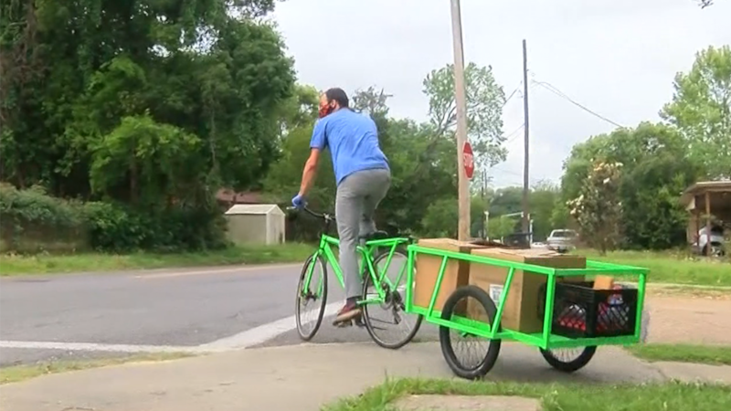Kincaid Nelson with Front Yard Bikes helps deliver meals to needy families.