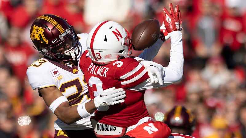 Nebraska's Trey Palmer (3) reaches for a pass as Minnesota's Jordan Howden (23) defends during...
