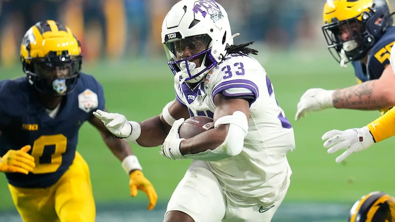 TCU running back Kendre Miller (33) runs against Michigan during the first half of the Fiesta...