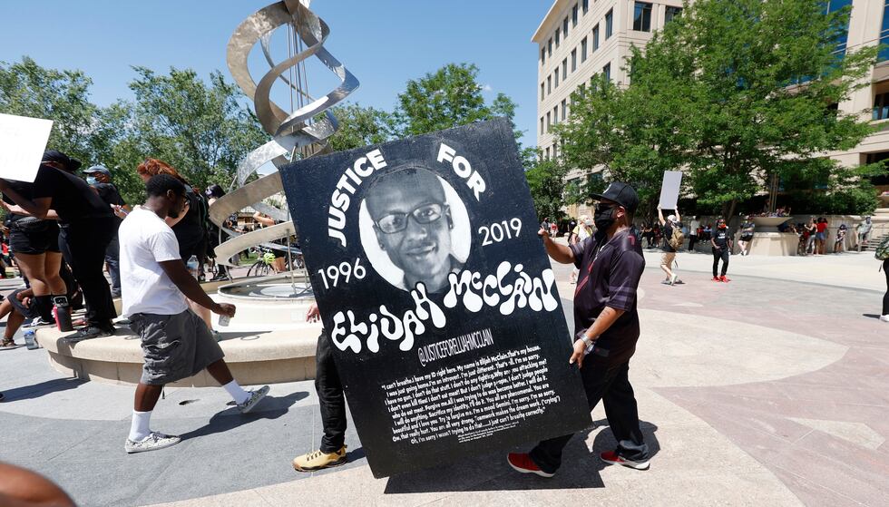 FILE - In this June 27, 2020 file photo, demonstrators carry a giant placard during a rally...