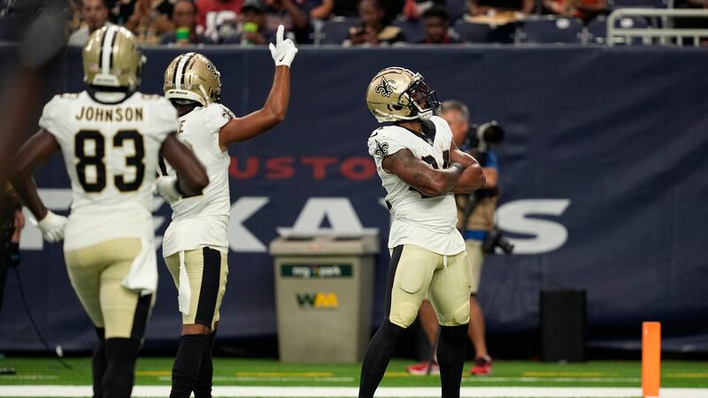 New Orleans Saints running back Dwayne Washington, right, celebrates after scoring a touchdown...