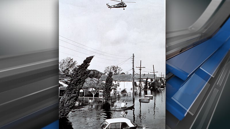 A helicopter hovers over a flooded New Orleans neighborhood in the wake of Hurricane Betsy.